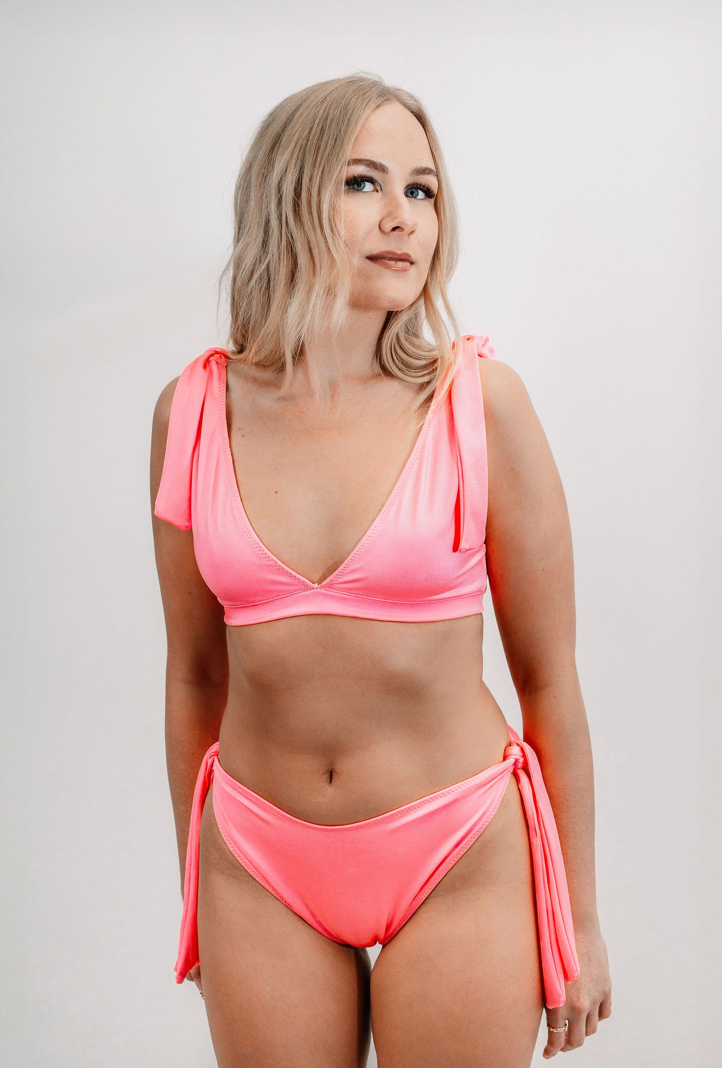 Charlotte wears the Marisol Bikini Top in size XS. Front view.