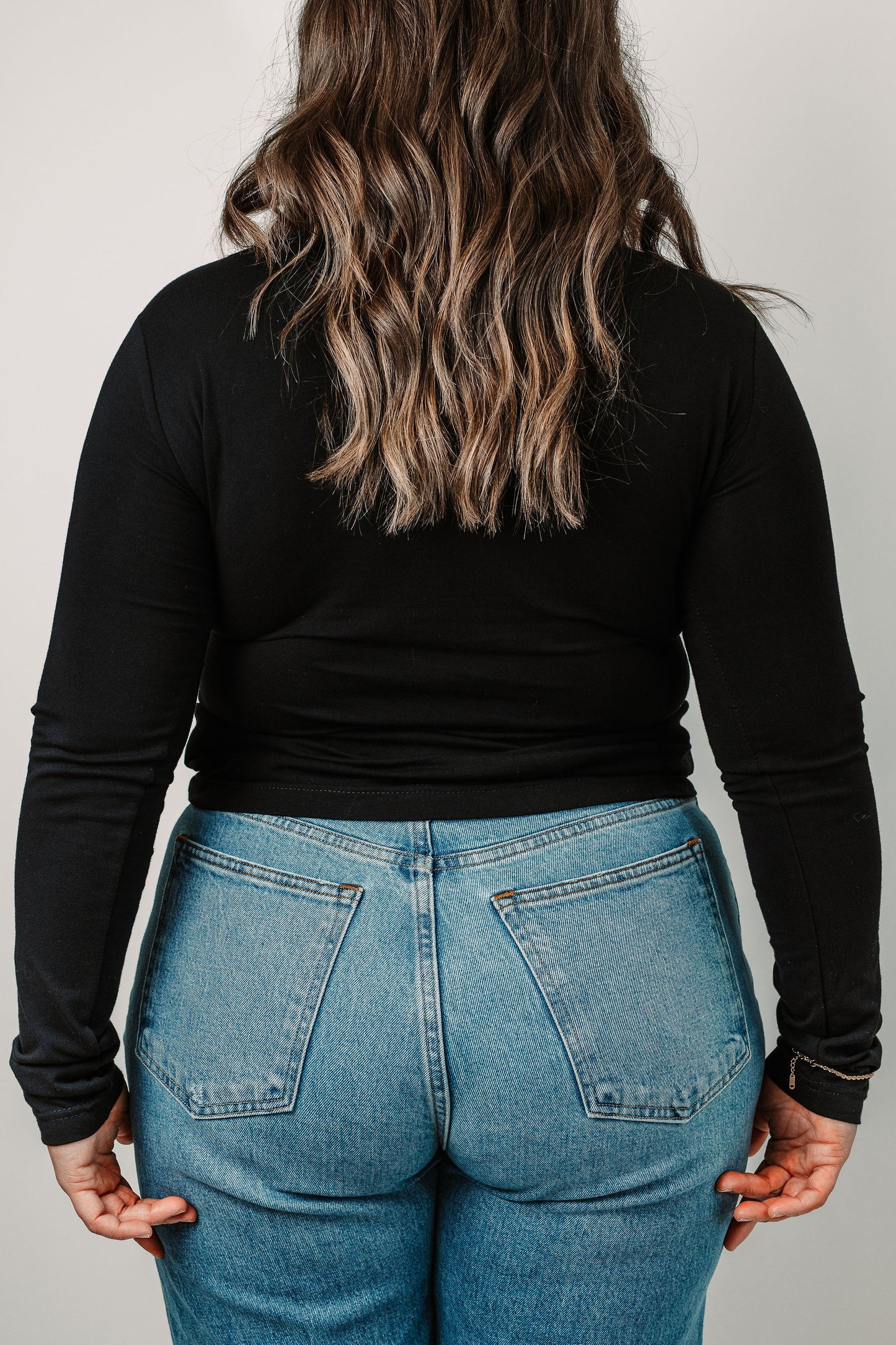 Cara wears the Black Riley in size Medium. Back view.