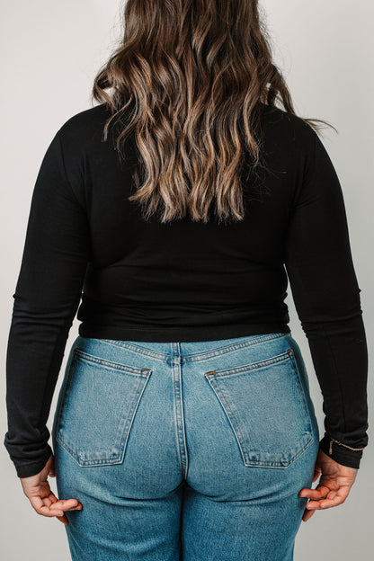 Cara wears the Black Riley in size Medium. Back view.