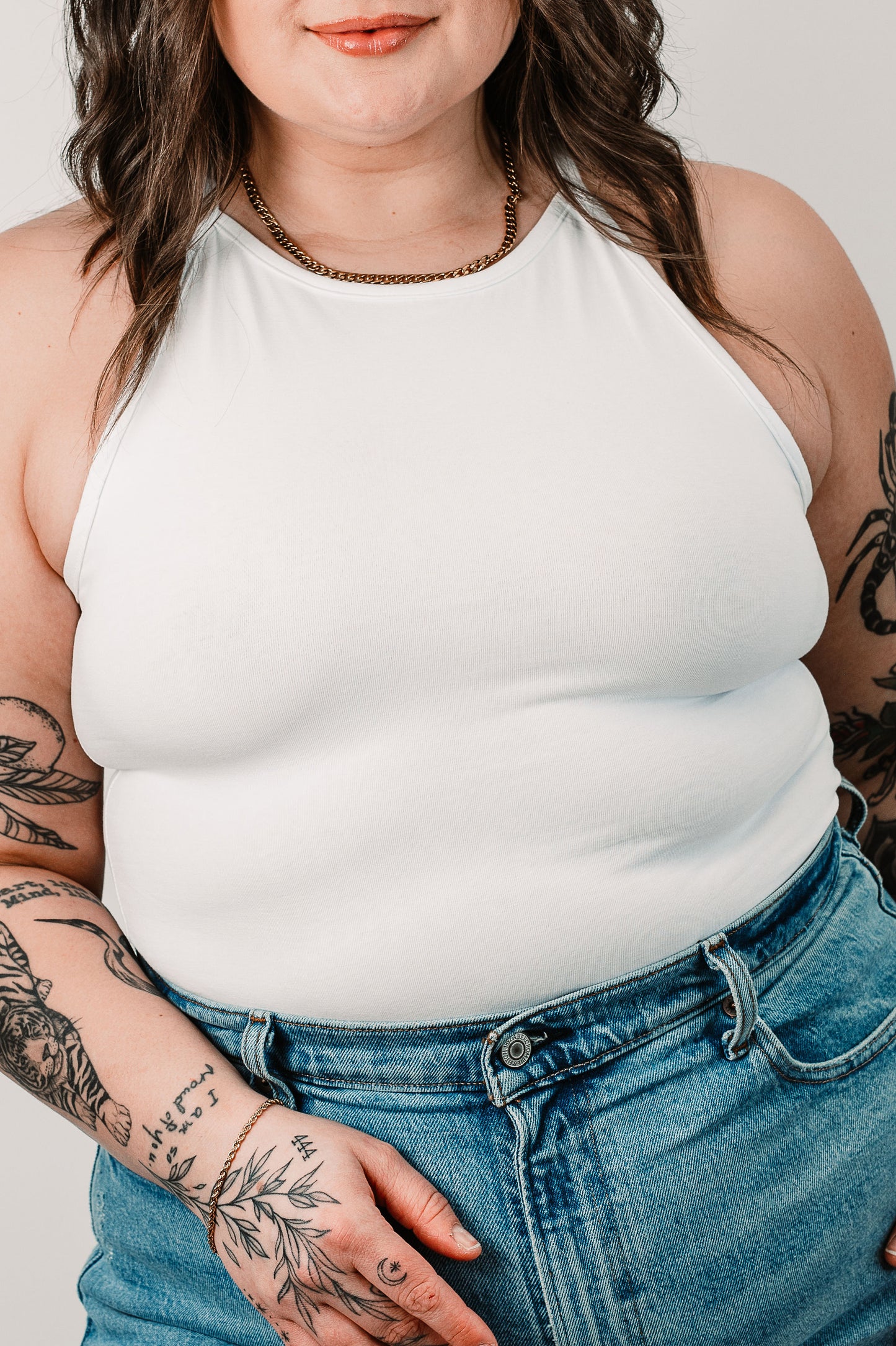 Cara wears the White Willa Bodysuit in size M. Close up.