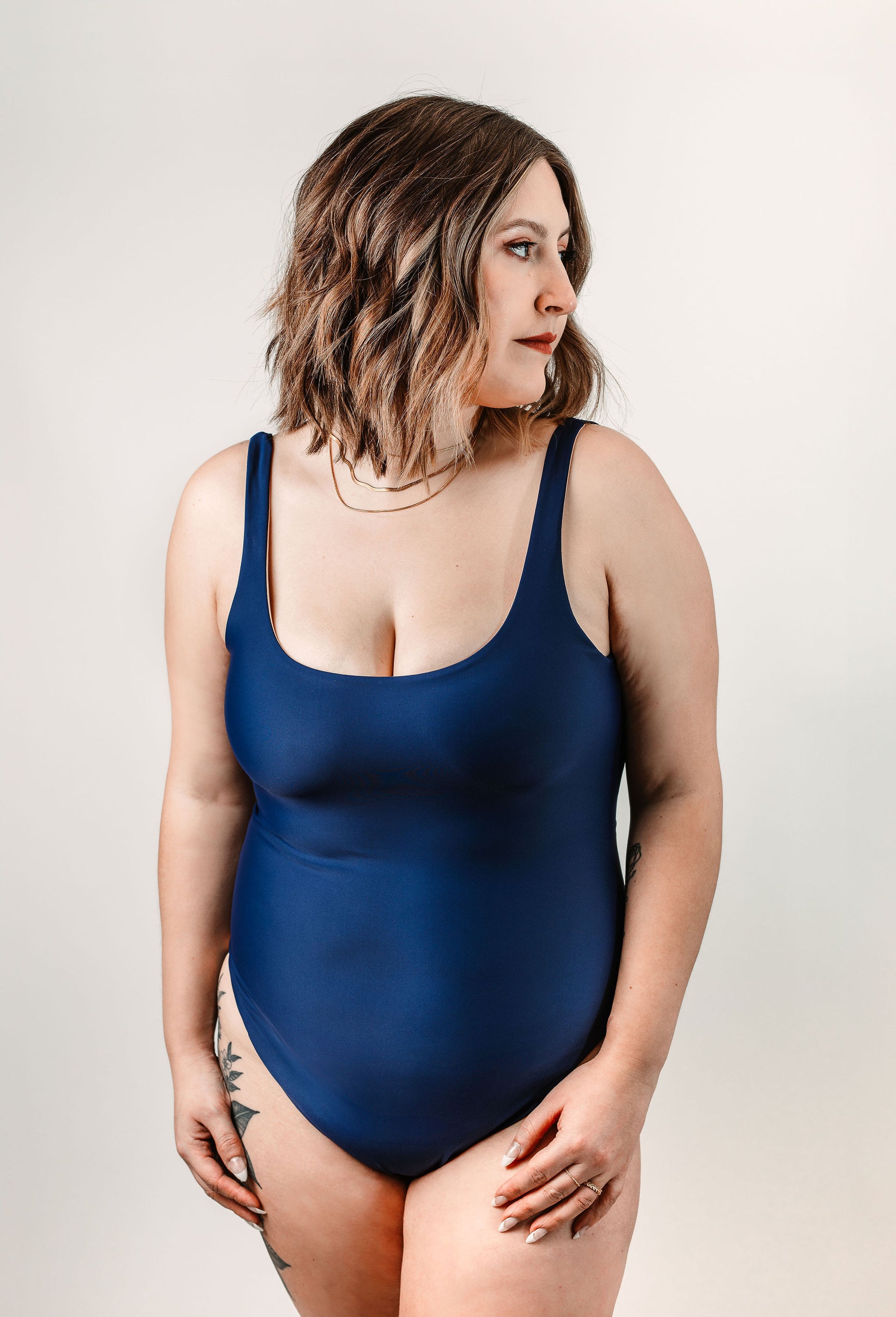Natalie wears the navy Sailor One Piece in size L. Front view.