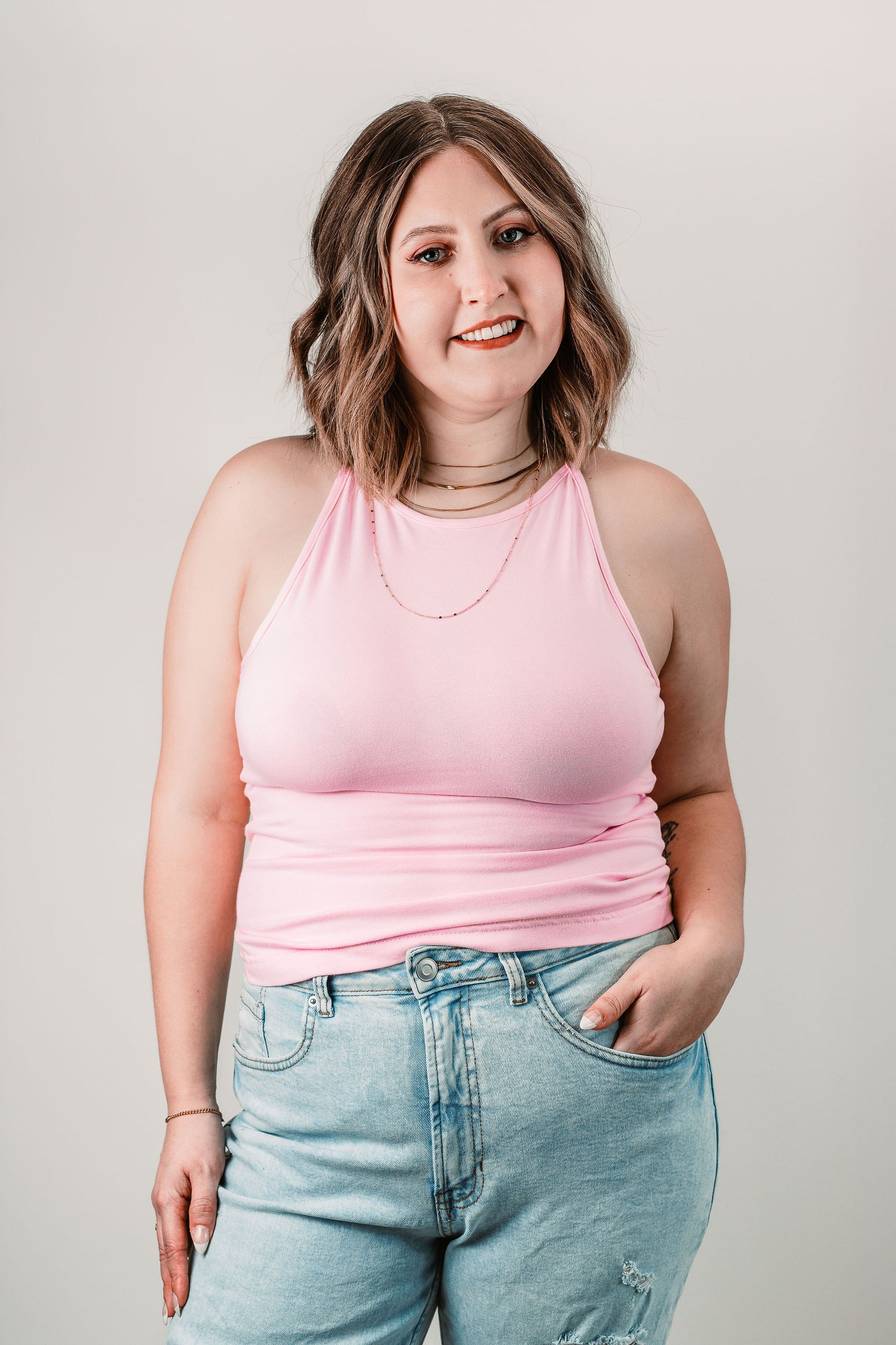 Natalie wears the Willa High Neck Tank in Baby Pink in size L. Front view.