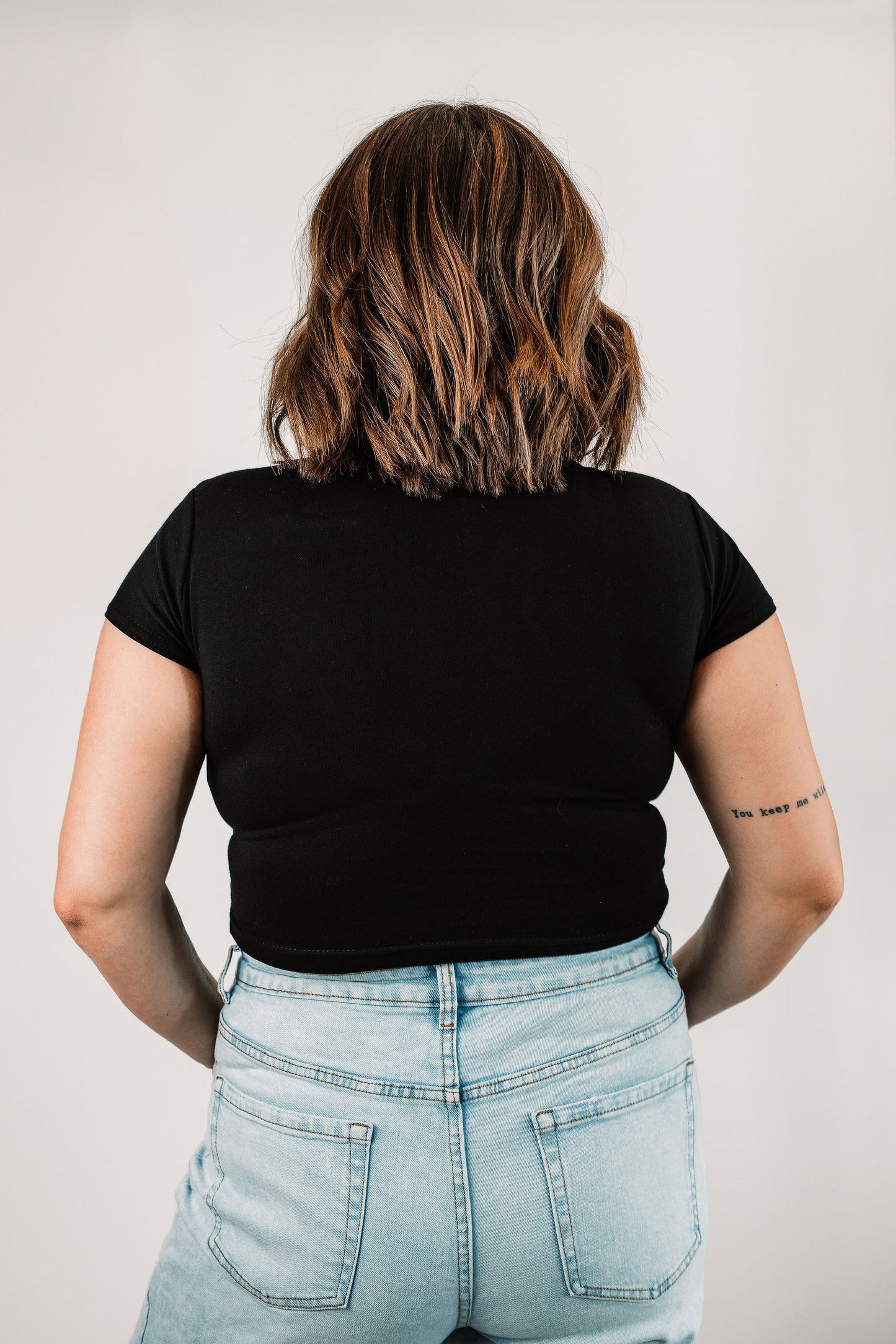 Natalie wears the Black Dallas in size Large. Back view.