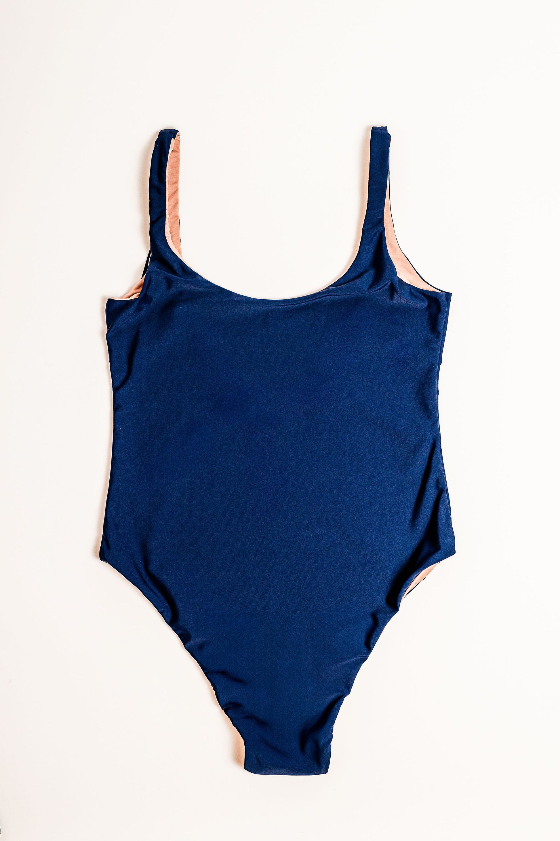 Flat lay of the Sailor Low Back One Piece in navy. Front view.